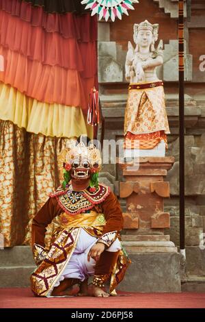 Traditional Balinese costume and mask Tari Wayang Topeng - characters of Bali culture. Temple ritual dance at ceremony on religious holiday. Stock Photo