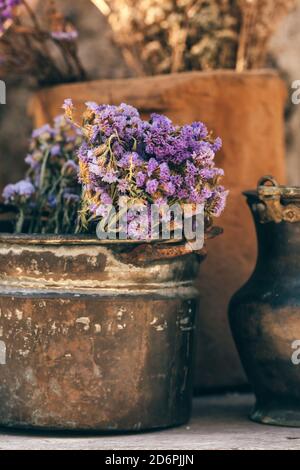 Closeup of a bouquet of dried flowers in vintage metal vase