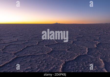 Hexagonal salt formations at sunset, Uyuni salt flat desert, Bolivia. Stock Photo