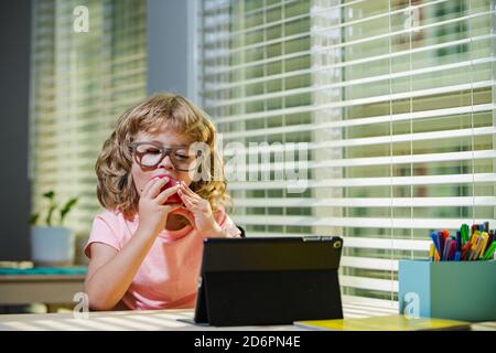 Kids education, knowledge. Schoolboy studying math during her online lesson at home, social distance during quarantine, self-isolation, online Stock Photo