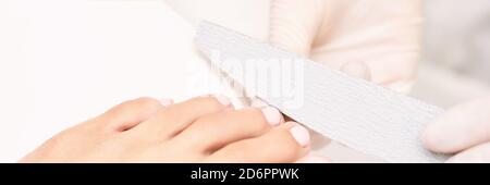 Classic pink wedding toe nail manicure on white backdrop. Spa treatment concept Stock Photo