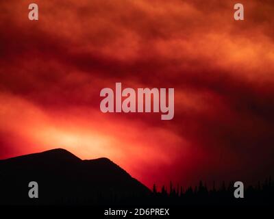 Cameron Peak Fire Sunset taken on Highway 72 in Colorado of smoke from the Cameron Peak Fire bruising the sky at sunset. Stock Photo