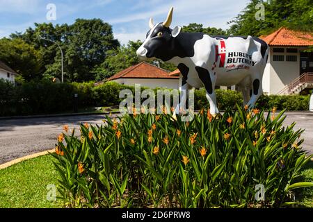 Huber's butchery life-size cow display outdoor with greenery surrounding it. Stock Photo