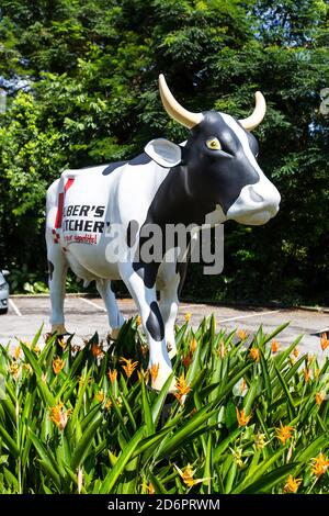 Huber's butchery life-size cow display outdoor with greenery surrounding it. Stock Photo