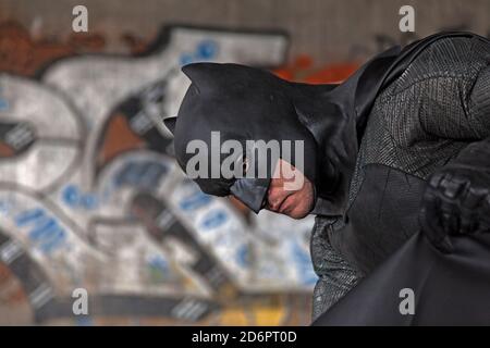 Umea, Norrland Sweden - September 5, 2020: cosplayer dressed as Batman with graffiti in the background Stock Photo