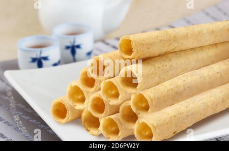 Egg roll biscuits on plate Stock Photo