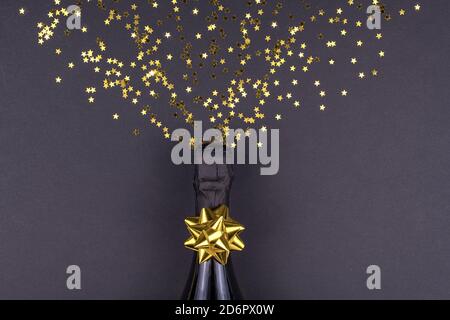 Celebration theme with champagne splashes on a black background with sequins. Christmas or New Year, background. Stock Photo