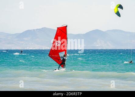 Kitesurfers and windsurfers on the beach at Playa los Lances, Costa de la Luz, Tarifa, Spain Stock Photo