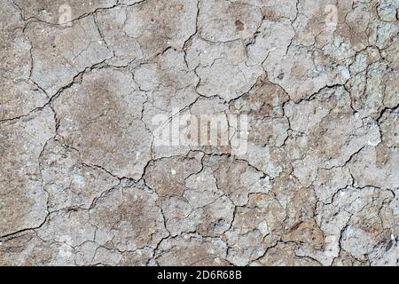 Natural background of dry cracked surface of volcanic land turned into desert Stock Photo
