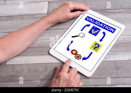 Validation concept shown on a tablet used by a woman Stock Photo