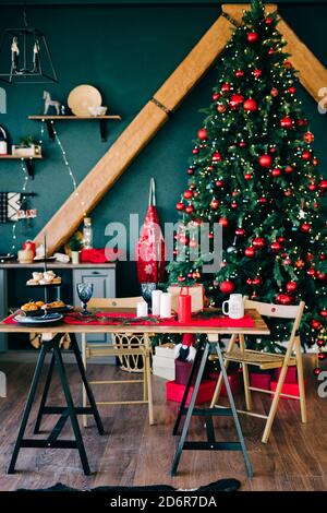Merry Christmas and happy holidays.Beautiful dining room in dark colors, decorated for Christmas.Christmas concept. Stock Photo