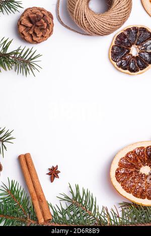 Christmas composition with dried citrus slices, cinnamon, anise, pine cones and fir tree branches, top view copy space Stock Photo