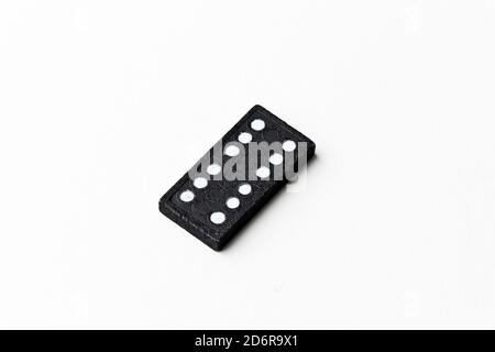 Dominoes is a board game in which rectangular tiles (tiles) are used, generally white on the face and black on the back, although there are many varia Stock Photo