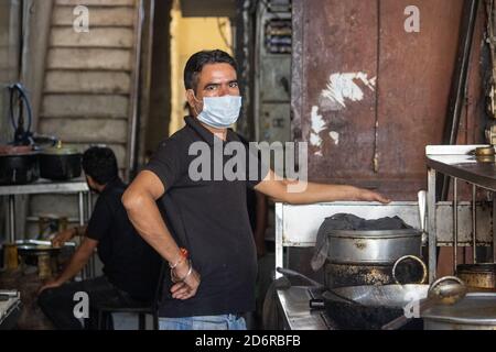 Dehradun, Uttarakhand/India-October 14 2020:A chef in a restaurant kitchen, wearing face mask in Corona pandemic in India. High quality photo Stock Photo