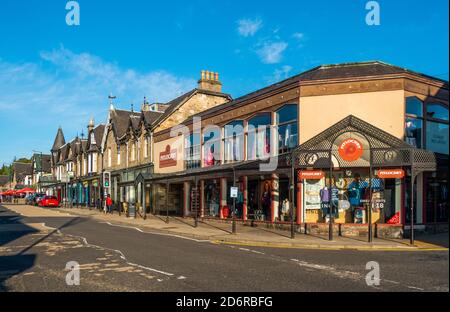 Shops, bars and restaurants in the main street in the town of Pitlochry, Perthshire, Scotland, UK Stock Photo