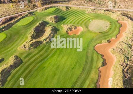 Aerial drone vibrant view of golf course in countryside, landscape field  with with a rich green turf and sand bunkers summer sunny day, a group of  gol Stock Photo - Alamy