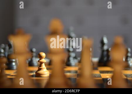 Close-up of a chess set with pawn in spotlight Stock Photo