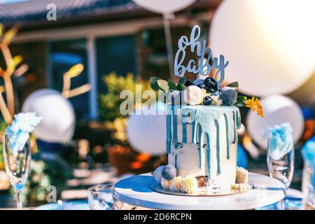 Baby shower blue cake on the decorated party table Stock Photo