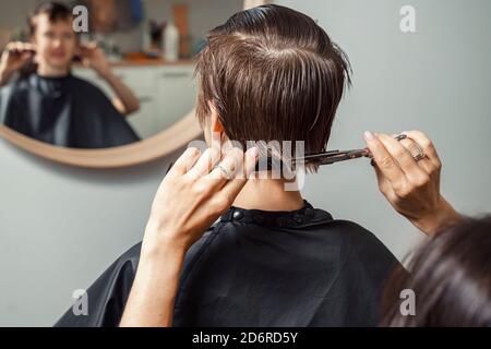 hair cutting process. woman with short brown hair Stock Photo