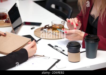 Closeup shot of woman hands using her smartphone Stock Photo