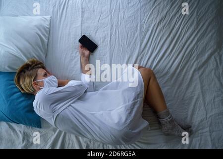 Top view of woman patient on bed in hospital feeling stressed, mental health and coronavirus concept. Stock Photo