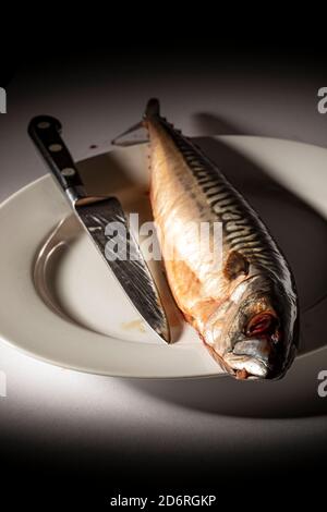 Raw mackerel on a plate,Cooked, Eating, Fish, Food, Fork, Gourmet, Grilled, Hand, Horizontal, Mackerel, Meal,filleted mackerel on a plate,A fish fille Stock Photo
