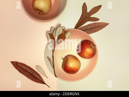 Autumn flat lay with plates, dry leaves and apples on paper background with shadow from sun Stock Photo