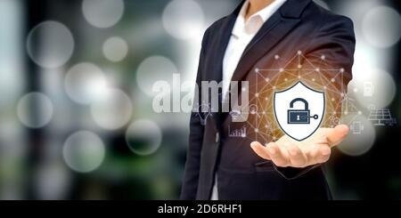 Businessman holding a shield icon, protection concept, computer network protection, safety and security. Stock Photo