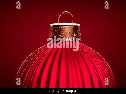 Red Christmas ball. Close up of vertically striped bauble against red burgundy background. Christmas decoration, festive atmosphere concept. Stock Photo