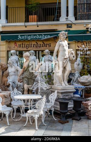 Madrid, Spain - October 20, 2020: Classic sculptures and garden furniture in antique store in El Rastro in Latina quarter in Central Madrid Stock Photo