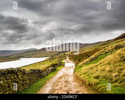 A track winds its way around the remote Scar House reservoir. Nidderdale. Yorkshire Dales Stock Photo