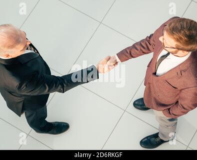 top view. business partners confirming the transaction with a handshake. Stock Photo