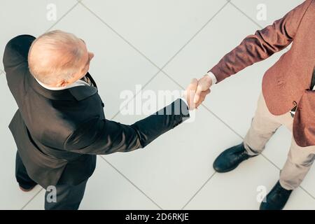 top view. businessman shaking hands with his business partner. Stock Photo