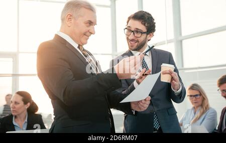 smiling business colleagues talking during a work break Stock Photo