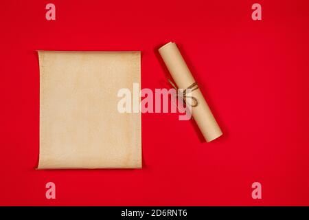 Parchment scroll for the to-do list on a red background. Glider, day planning, place for text and for entries. Stock Photo
