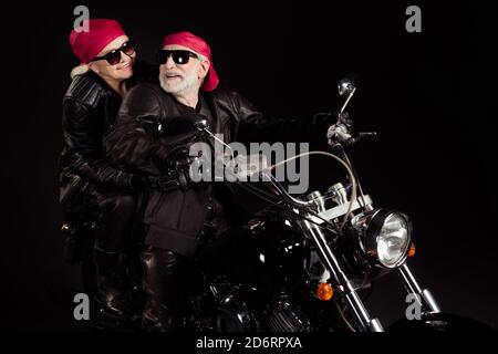 Photo of aged bikers grey haired man lady couple drive vintage chopper moto traveling retired feel young wear trendy rocker leather jacket pants Stock Photo