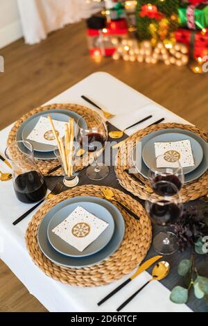 From above of ceramic plates near glasses of red wine and cutlery on table during festive event Stock Photo