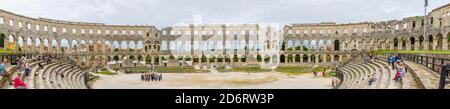 Panoramic view of the walls and interior of the iconic ancient Roman amphitheatre and arena at Pula, Istria, Croatia, a leading tourist attraction Stock Photo