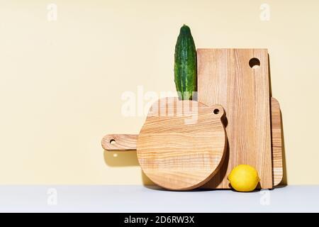 Wooden cutting boards of various shapes on bright studio background Stock Photo