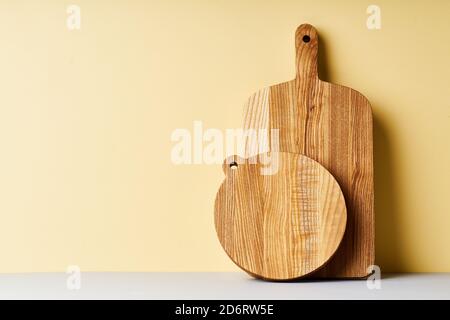Wooden cutting boards of various shapes on bright studio background Stock Photo