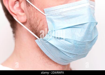 Close-up face of man with protective mask, medical mask on human face Stock Photo