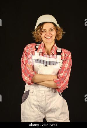 Female engineer in hardhat. woman architect in checkered shirt inspecting construction. Building project management and audit. portrait of an industrial engineer. girl working engineering in industry. Stock Photo