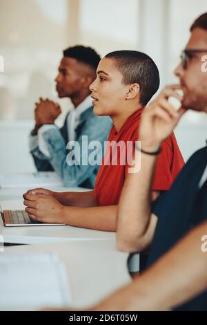 Teenage students paying attention to lecture in classroom. Students studying at the college classroom. Stock Photo