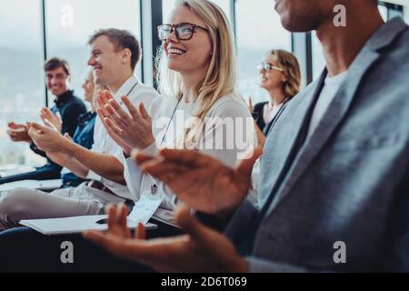 Team of businesspeople clapping hands while having a conference. business professionals applauding at a seminar. Stock Photo