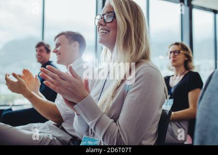 Group of businesspeople clapping hands at seminar. business professionals attending a conference clapping hands. Stock Photo