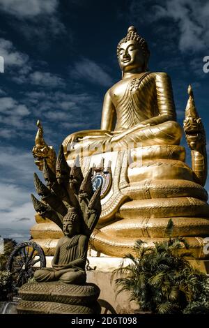 Thailand - 2019. Phra Phutta Ming Mongkol Akenakiri. Golden buddha with dragon heads in the sun. Stock Photo