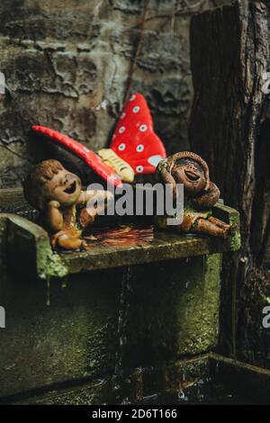 Thailand - 2019. Phuket Botanic Garden. Sculpture of children. They play with the water. Background blurred for artistic idea. Stock Photo