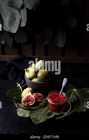 High angle of homemade jam in glass jar made of ripe fresh figs placed on table in garden Stock Photo