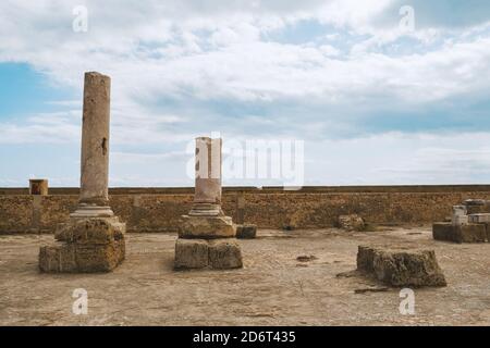 Two broken columns of ancient Carthage in Tunisia against the sky. Stock Photo