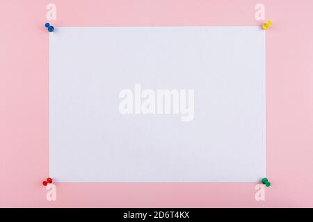 white sheet fastened with clerical multi-colored buttons Stock Photo